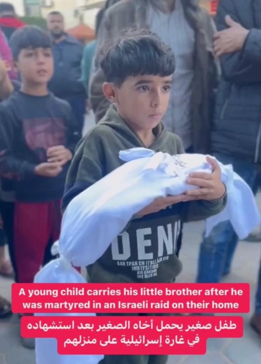 A YOUNG CHILD CARRIED HIS DEAD BROTHER