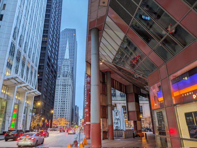 The red pillars of the atrium entrance as seen from the street at dusk