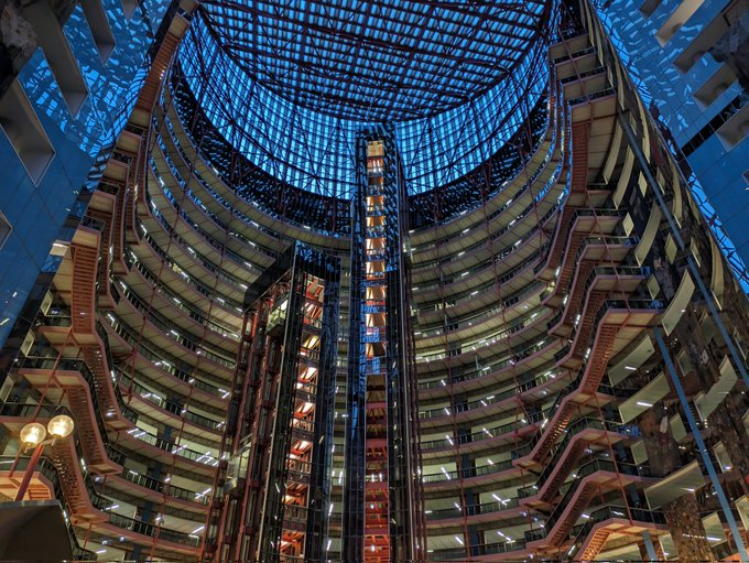 The inside of the atrium, looking up at the blue twilight sky shining through the glass ceiling