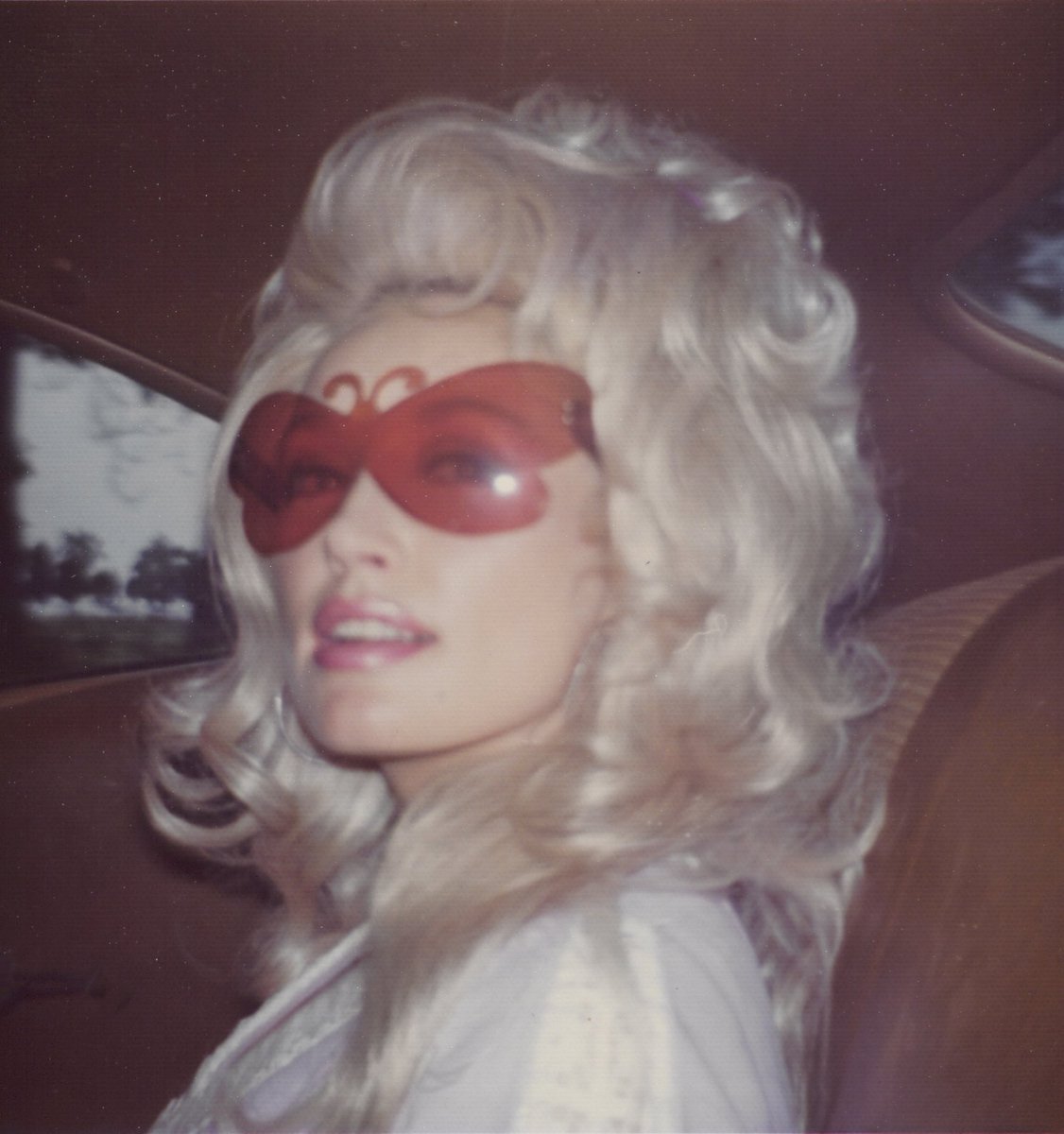 Dolly with her butterfly sunglasses in July 1973, from Behind the