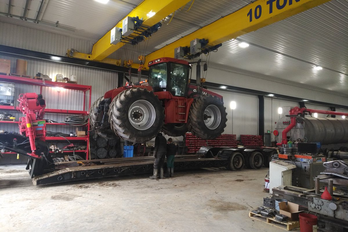 The use of shop cranes never gets old, one men loads 4WD tractor with transmission problems on the float with ease.