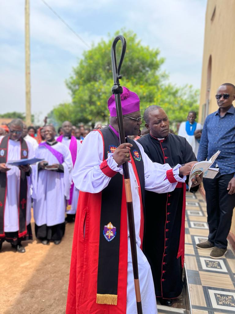 Bishop Naimanhe and the Provincial Secretary Busoga Diocese proceeding with the Inauguration Ceremony of St Mathew's Church of Uganda Kiige, Kagumba Subcounty