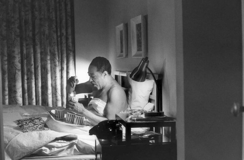 Duke Ellington eating ice cream alone in bed.