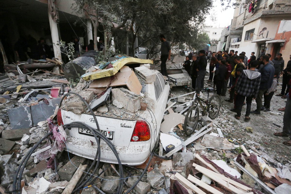 Residents and civil defense teams conduct search and rescue operation under the rubbles following an Israeli attack on building in Dair El-Balah, Gaza Strip, on January 01, 2024. Photo by Ashraf Amra