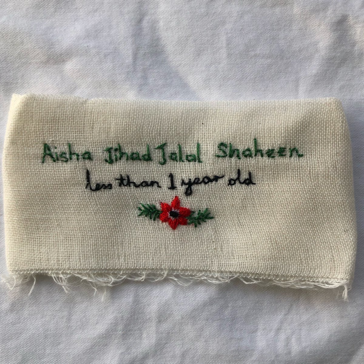 RobinIlexStudio's tweet photo. Aisha Jihad Jalal Shaheen 🕊️ 
For  #ThreadsOfSolidarity I embroidered Aisha’s name, who was less than 1 year old when she was killed during Israel’s current bombardment of Gaza. 

Under her name and age is a Palestinian poppy, the national flower. On gauze, named after Gaza. https://t.co/OzM1OpR7i6