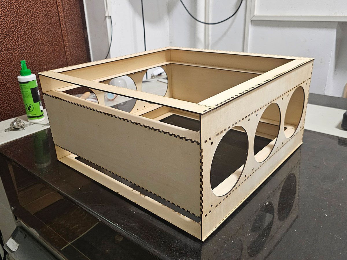 NukitToBeSure's tweet photo. First test assembly of the parametric version of the Nukit Open Air Purifier. This is generated by a web app so you just select how many fans, what size, what sides of the box they are on, how many filters, what size, and it automatically generates the files for the lasercutter. Then just fit and glue.
 
This is a horizontal version designed to be hung from a ceiling. Could use a coat of paint, but otherwise not bad🤔 Any school with a 6040 lasercutter and some wood glue can whip them up on the cheap.