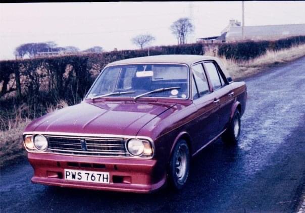 Mikellfixit's tweet photo. @70s80s90sKids I had one almost exactly the same in 1976. The alloys were slightly different. Unfortunately, although nowadays I have over 25,000 pictures on my iPhone I don’t have one picture of it. My interest in photography didn’t start until the 1980’s. Here’s one of my MkII Cortina in ‘79 https://t.co/FfEX3cw9Ri