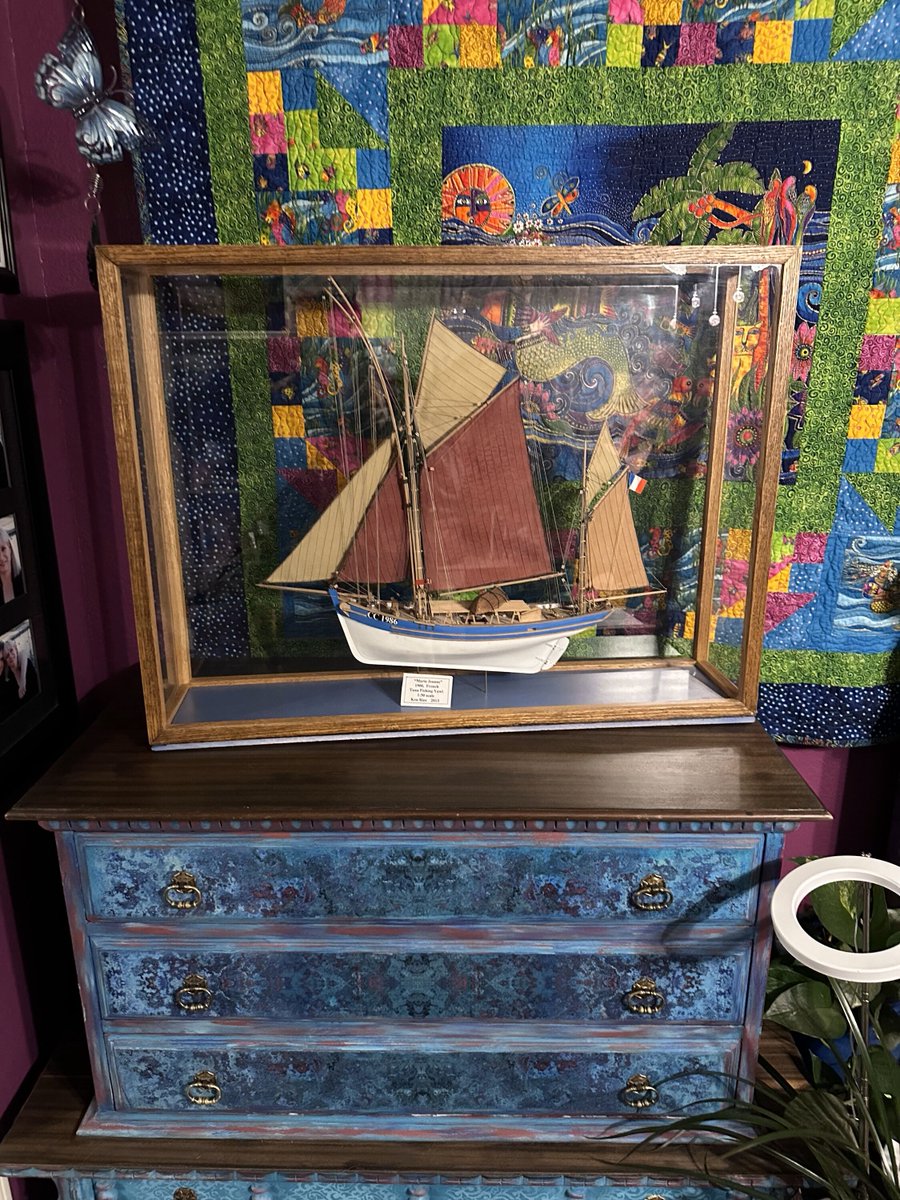 CheyenneMcCray's tweet photo. The ship model my father-in-law made and gifted to me is in its new home in my office. A Laurel Burch mermaid quilt that my mom created is behind the model, and Martin thinks a mermaid makes for the perfect background!

#shipmodels #mermaidsrock #ilovequilts #cheyennemccray 🧜‍♀️ ⚓ https://t.co/hjP9g0zOYh