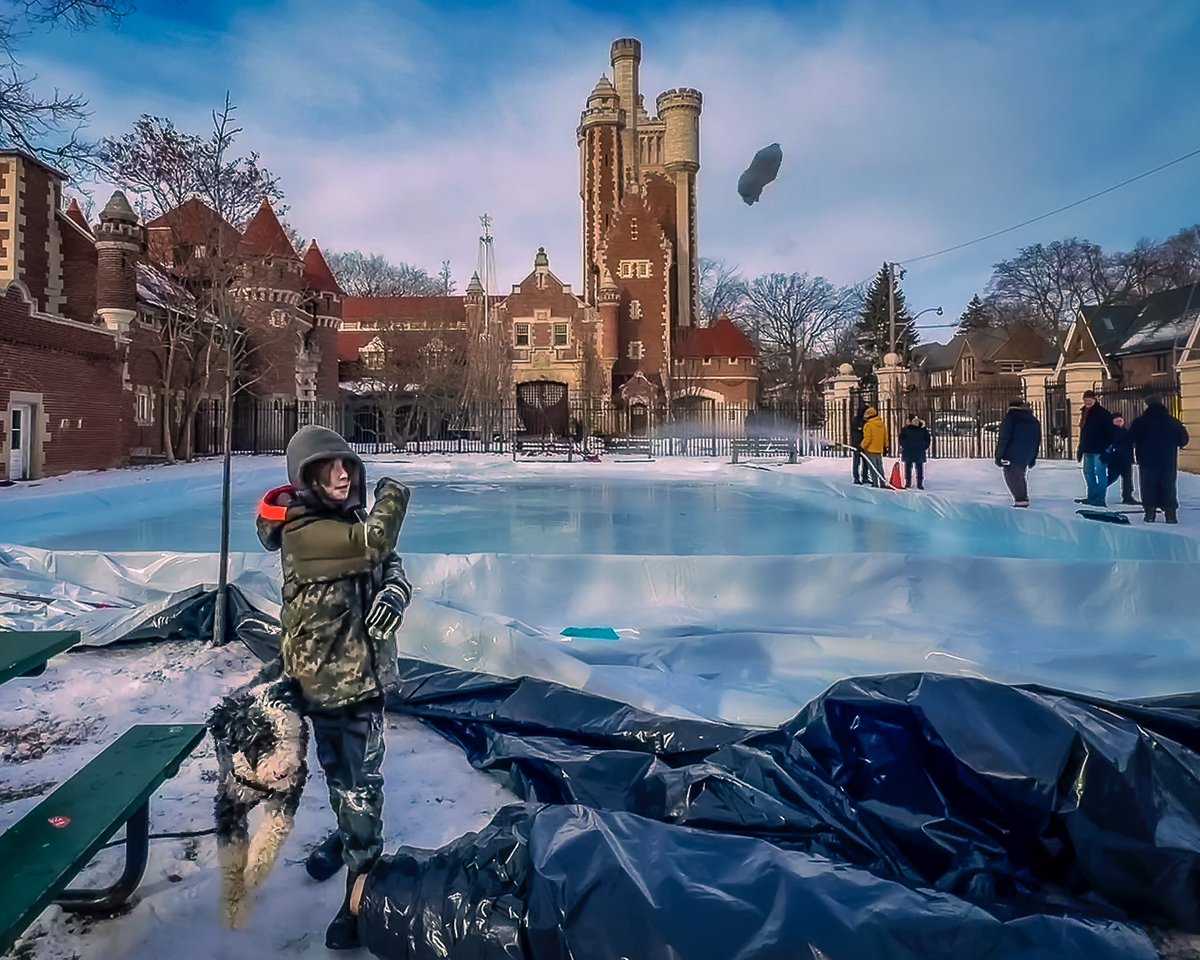 lapegpix's tweet photo. There’s a whole lotta Canadiana happening here: Neighbours coming together to make an outdoor skating rink in front of Casa Loma while a boy throws a snowball for his dog under beautiful blue-bird skies in Toronto. Yay winter! ❄️ 
#canadianwinter #torontolife #outdoorskating https://t.co/bbJnYjCt83