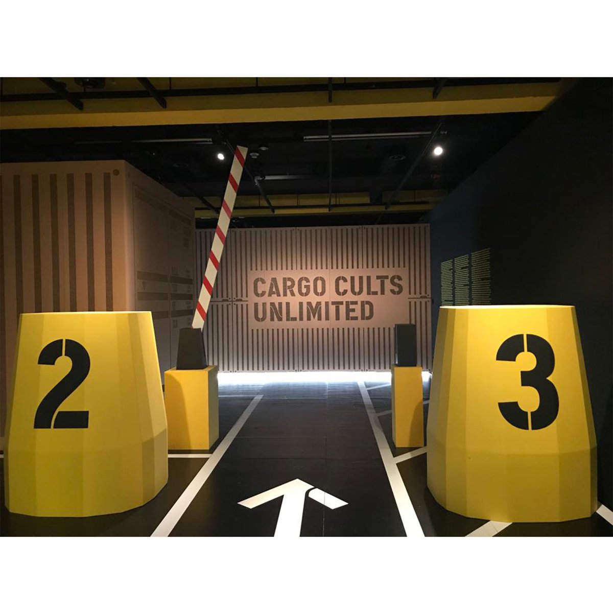 osaze_amadasun's tweet photo. 📦🛳️ The "Cargo Cults Unlimited" exhibition is centered around the theme of the globalized economy. Set in a make-shift port overlooked by offices. Each container within the maze-like layout of the show features installations addressing topics relating to the globalalized economy https://t.co/Gx4V7PsGhF