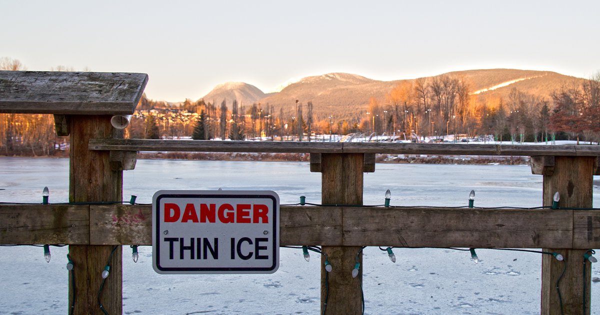 A sign posted at a local lake that reads Danger Thin Ice