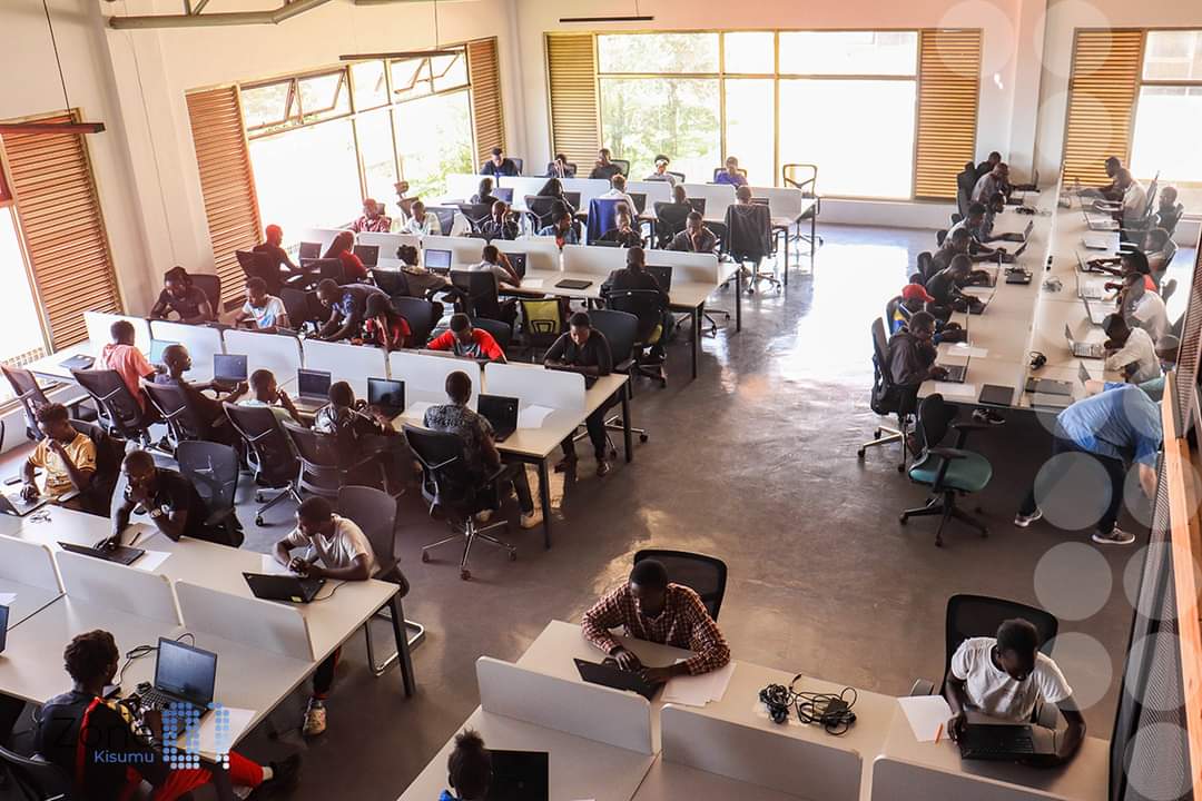gabrieloguda's tweet photo. Let me beat you guys a story.

Three weeks ago I found myself stranded in Kisumu. One of the organizations that had been sitting on my monies had warned me that if I did not find the Kenya Revenue Authority (KRA) offices in Kisumu to set up my eTIMS account within two days, I was going to see my December voucher on Viusasa.

I did not know where it was, so I was told to find my way to the Mamboleo junction where I’d see a giant architectural monument overlooking the newly constructed Kisumu-Kakamega overpass. Kenya’s Europe has their own expressway that doesn’t flood in the rain, and it terminates at the Lake Basin Mall.

Mamboleo junction should be the last of the places that should confuse me. I grew up in Miwani and that’s the route we would use every time I went communing with my ancestors in Seme, or crisscrossed the city to and from Maseno School for Sons of African Chiefs, established in 1906.

Those days, Mamboleo was just a pocket-sized dusty junction marred by a bedlam of coughing cane trucks wrestling with overloaded matatu minivans struggling up the Kiboswa hill. When I went there three weeks ago, Mamboleo not only had a stadium that aspires to be international, but it also anchored the Lake Basin Mall that has more potential than Jude Bellingham.

Lake Basin Mall doesn’t get the credit it deserves. On the North Wing is a spacious automobile-care centre where I found school buses coming for medical checkup. There’s a welcoming water fountain struggling to jumpstart its nozzle in the centre circle, and if you dribble one floor up the left wing, you will come across an artificial football pitch waiting for you to unlock your talent at a revolutionary tuition-free coding school called Zone 01 Kisumu.

From the outside, @Zone01Kisumu looks like just any other tenant whistling in clients coming into the Lake Basin Mall. But looks can be deceiving. You do not need to get past the last step into the upstairs hallway for you to discover you’re now entering a mind-blowing space full of aspiring tech gurus ready to wow you with raw talent.

Built and fine-tuned from the learnings of acclaimed information technology wizards the field has ever produced, Zone 01 Kisumu is the brainchild of @odedejames, a computer science whiz-kid who has modelled more trailblazing tech hubs from the palm of his hands than your average clay works factory. 

James is credited with not only raising funding from Google, but also overseeing the implementation of Computer Science for High School (CS4HS) students program, named by Facebook among the 40 young Icons of Change in Africa, and built the Western region’s first co-working tech space. Some of us, given half the things this guy has done with his life, would be contented with retiring to the village and taking up a fulltime career in refereeing hippos boxing by the lakeshore through the evening sunset.

But James is not some of us. From the things I saw when I went to kill time over there as I waited for those KRA guys to thank the Lord for a new day, James is a man on a mission, and it won’t be long before Zone 01 Kisumu becomes the premier tech solutions company South of Takaba North of Longido.

Usually when you arrive at the registration desk of any company, the questions you’re asked not only determines the seriousness of the organization but also whether you’d sacrifice your fulltime job for a shot at being the next big thing. Zone 01 might have computer programming at its core, but that place is more than a tech hub.

The world of ICT has become extremely fluid and needs people who can adapt to the fast pace without missing a beat. The guys at Zone 01 Kisumu begin from the premise that creators are not taught, they are innovative with ideas that just need to be polished, and how can you nurture thinking outside the box when you have a teacher sitting there belching out instructions from a manual modelled around tunnel-vision?

Which is why the Zone 01 pedagogy is premised around peer-learning, where those who make it through the filtering stage only get to be given rules of engagement and nothing else. 

They get to decide when to come to the hub and when to leave, there are no strict instructions and if you prefer learning at night when you’re most creative, you will find your fellow night owls already at the hub spreading the cheer for you to be sufficiently motivated.

When it was my turn at the inquiry desk, the dangerously beautiful lady with an infectious smile and bewitching eyes, noticed I monetarily lost concentration when she mentioned that I could try exploring my potential in data engineering. I had to check twice whether I was in a witchdoctor’s den, because how did this woman know that research is my daily bread?

“Data is the new oil”, she began speaking like Albert Einstein, “and the world is looking for data engineers to mine this precious gem.”

It was like I had just discovered my purpose in life. You mean I had been an engineer all my life without knowing, only that I did not have the tech skills required to break my professional ceiling and have the world at my feet?

“That’s not all”, she interrupted my dreams with another zinger. 

“Here, we also help our creatives to become fulltime software engineers, AI developers, 3D animators, e-commerce consultants, business intelligence analysts, computer forensics investigators, game developers, block chain specialists, telecoms engineers, network administrators, cyber security analysts, and mobile app developers.”

At that point, I just told her to save my time and give me the application form for me to fill, only to be informed not so fast. 

To make it to the crucible I was required to first log into their website and go through a rigorous online cognitive test consisting of two video games. Only when you pass the test that you will be admitted into the shark tank called a piscine, a French terminology simply translated to, “swim or sink.”

“The setup you see here is one of a kind”, Dorcas Owino, the Managing Director, tells me as she leans over to point to the board. Through the partnership with the County Government of Kisumu, United Cities and Local Governments of Africa (UCLGA) and Lakehub, Zone 01 Kisumu has managed to harness the power of collaborative synergy to arrive at the best talents the region can produce.

They gave me a t-shirt for my troubles. I said I wanted a black one not only because that’s the week we were mourning back home but also because how many people do you know who were in dead professions and needed an eye-opening career-talk to kick them back to life again?

“When you make it past the piscine, we give you a five year job contract. The first two years, you'll be trained on these key competencies, but for the last three years you'll be given a real job, fully-funded, and for those five years you're paid. We start with stipend for the two years you'll be under training, and then a competitive salary for the next three years when you're on the job.”

“Did I hear that right?”

“Yes, you did.”

“You pay me as I study, for real?”

“Go and take the test, and if you make it to the training stage, come and see for yourself.”

Times are currently tough for everyone – and if you live in Kenya, making it back home with a packet of milk is a miracle by itself. The unemployment rate is blowing through the roof and the bulging youth population is unforgiving in its surge. Lately, people have done worse things to make ends meet, even selling their eyeballs for the price of a mathematical set.

“At Zone 01 Kisumu, they can come over and skill themselves at some pay”, Dorcas confirms, just in case I didn’t hear her the first time. “You do not require any programming experience or academic qualifications to apply, for as long as you’re above 18 years old, you’re welcome to upskill yourself and who knows, you may be the next big thing.”

These people don’t know what they did to me. This year, I’m going to do some radical things in my life and you will hear about them very soon.

Believe me.