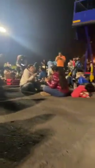 ANI's tweet photo. In a viral video, passengers of a Delhi-bound IndiGo flight diverted to Mumbai (confirmed by airport sources) due to operational issues are seen eating and sitting on the airport tarmac at Mumbai Airport.

(Screengrabs from viral video) https://t.co/xNdiW7HqUv