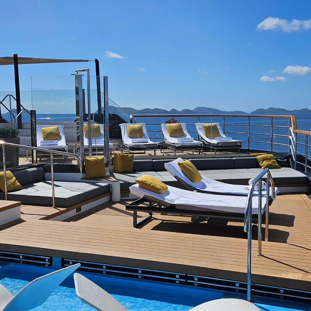 Feel the warm Caribbean sun kiss your skin as you sink into a plush lounger at The Pool on board Evrima.