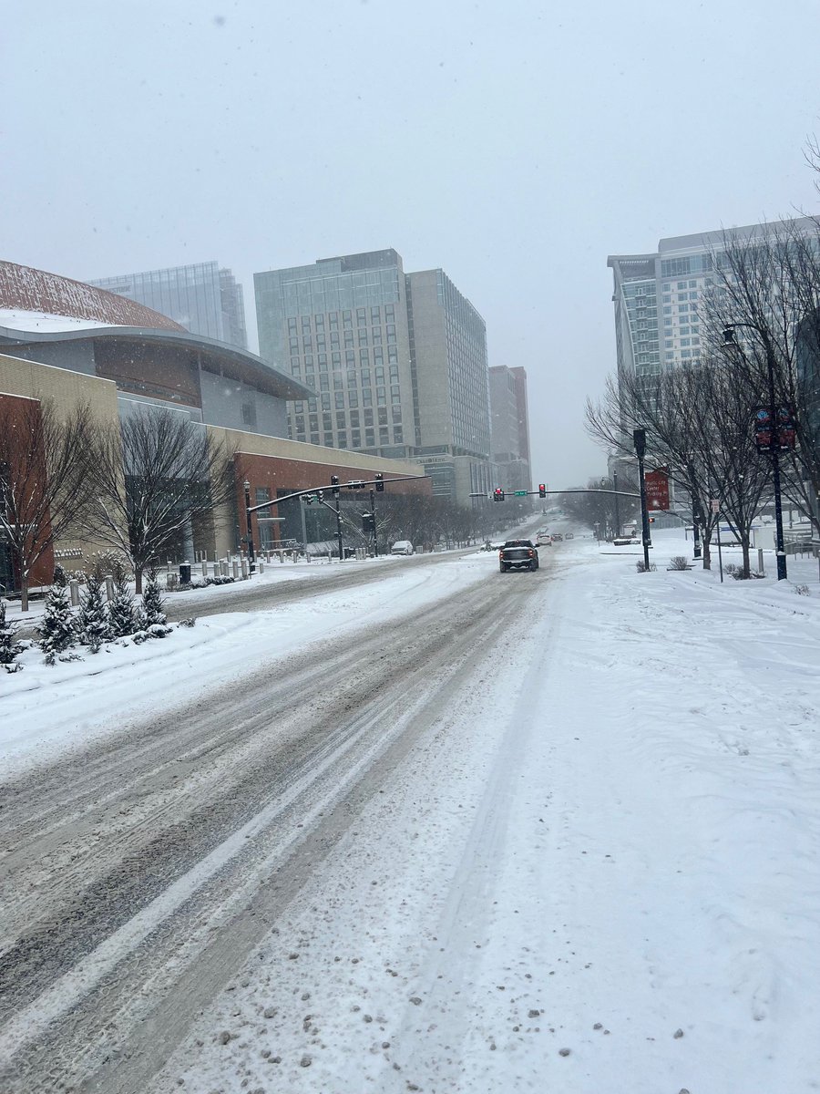 MNPDNashville's tweet photo. Here are noon hour conditions in downtown Nashville. Please stay off the roads unless traveling is a necessity. With snow continuing, road conditions across the city are treacherous. https://t.co/PqaIpdSSnK