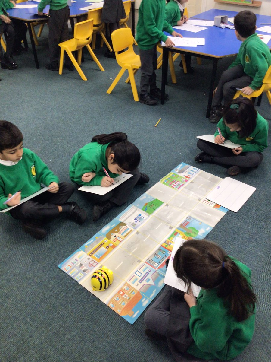 BeaumontYear2's tweet photo. We are programming algorithms in the Beebots to direct them to places on the map. We are using language life turn, forwards, backwards, left and right. #beaumontcomputing https://t.co/oWtkJjEp0M