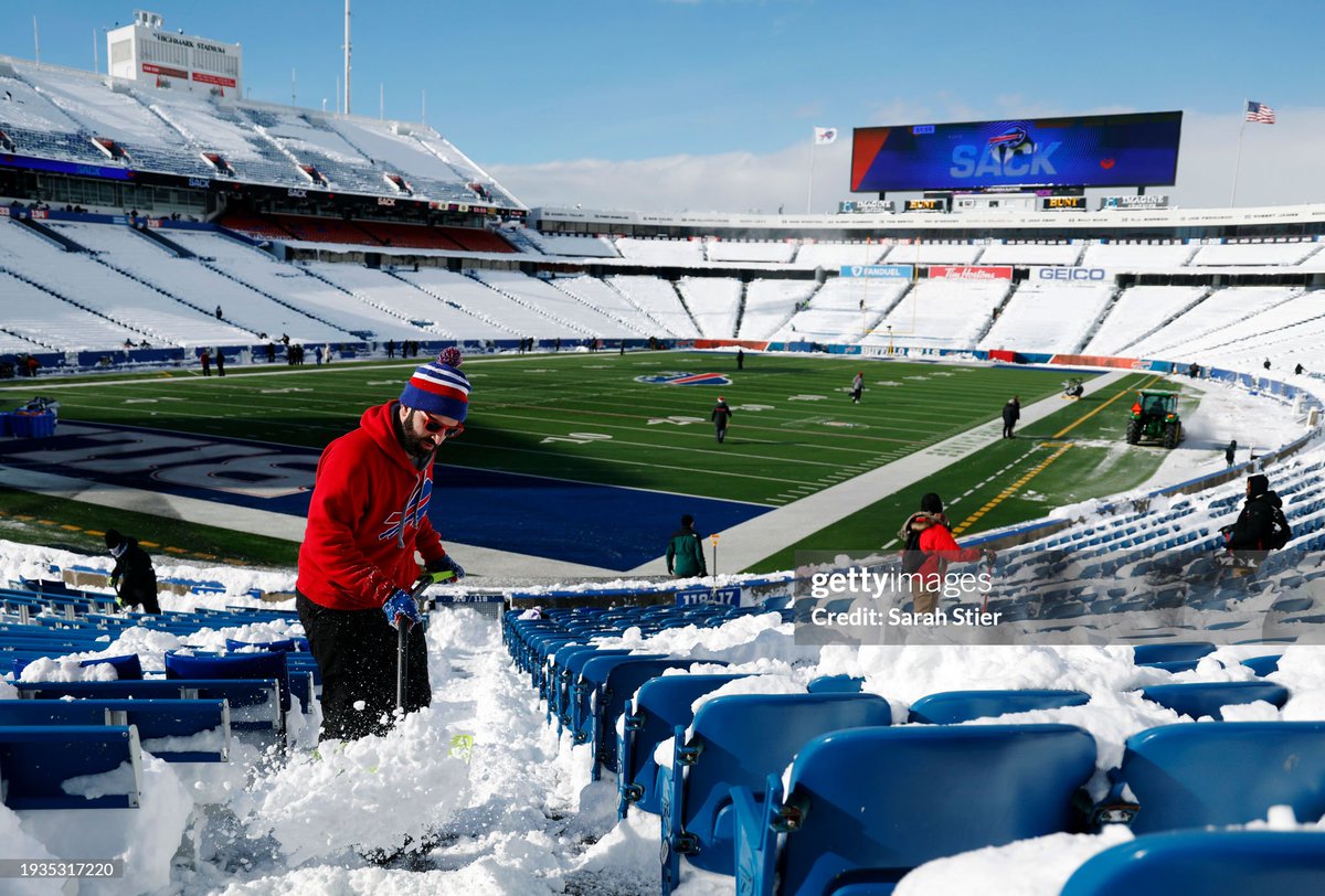 Local residents Brady Reinagel and Rob Limoncelli shovel snow before today's AFC Wild Card playoff game between the Buffalo #Bills and Pittsburgh #Steelers at Highmark Stadium in Buffalo, NY. The Bills hired residents to help clear snow after a blizzard caused the game to be…