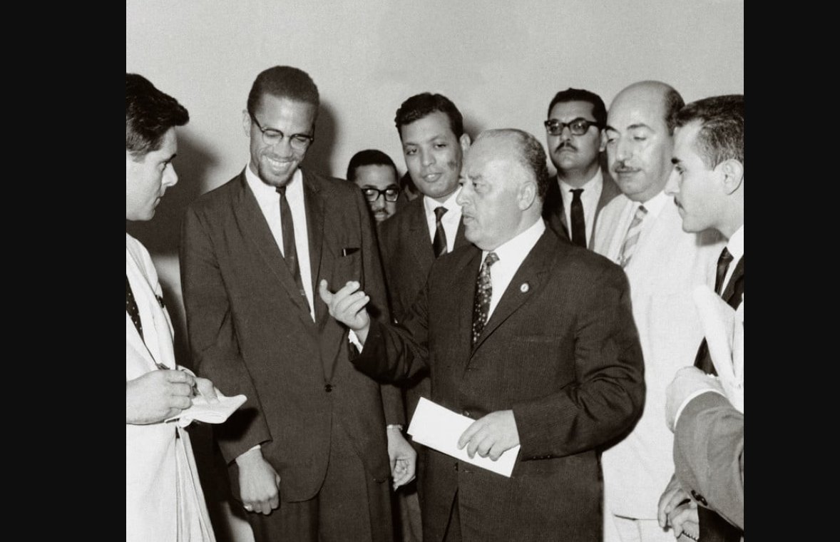 asadabukhalil's tweet photo. On MLK Day, here is Malcolm X in Gaza (Ahmad Shuqayri, first head of the PLO, is to his left, speaking). https://t.co/Nl20tlqtYp