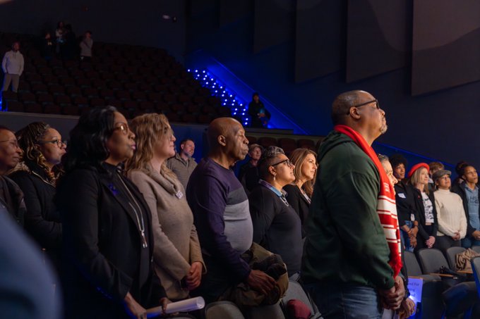 A group of community members watch the 2024 MLK Day celebration.