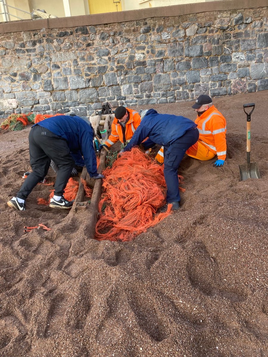 Teignbridge's tweet photo. Staff from our Coastal, Blitz &amp; Resorts Teams have cleared a large piece of discarded trawler netting that washed up on Teignmouth Beach.  As well as being an unsightly hazard, discarded netting can continue to float for years ‘ghost’ fishing in the ocean threatening marine life. https://t.co/nbMTs7jBGg