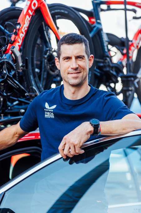 Imanol Erviti behind the door of an INEOS Grenadier team car.