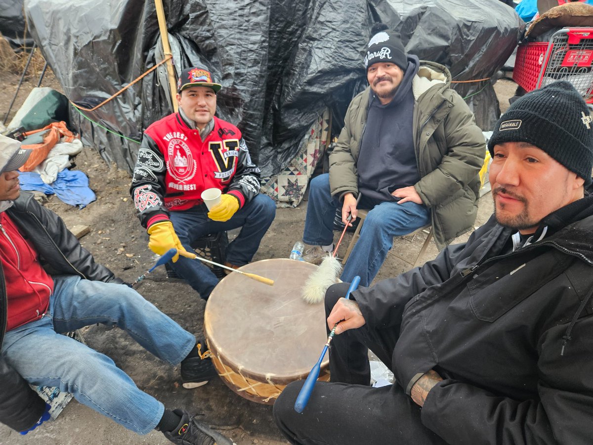 These four men, not residents at the camp, came out to support their Native community. They are currently doing a drum circle and singing Native songs.