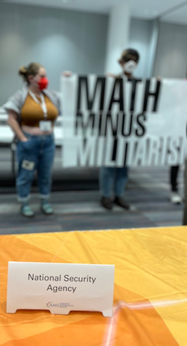 jm_collective's tweet photo. Conference goers at #JMM2024 are standing up for a  #MathMinusMilitarism. While the JMM welcomes the NSA to recruit mathematicians for secrecy and surveillance, we refuse to use our labor to aid and abet war and imperialism! https://t.co/au1tZbWPBM