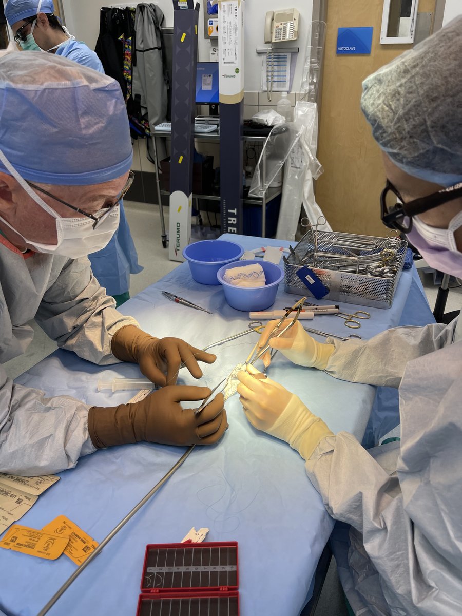 Drs. Peter Nelson &amp; Lucas Phi working on a physician-modified endograft (PMEG). 💪