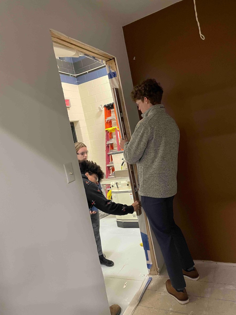 Junior construction students learn how to hang doors!