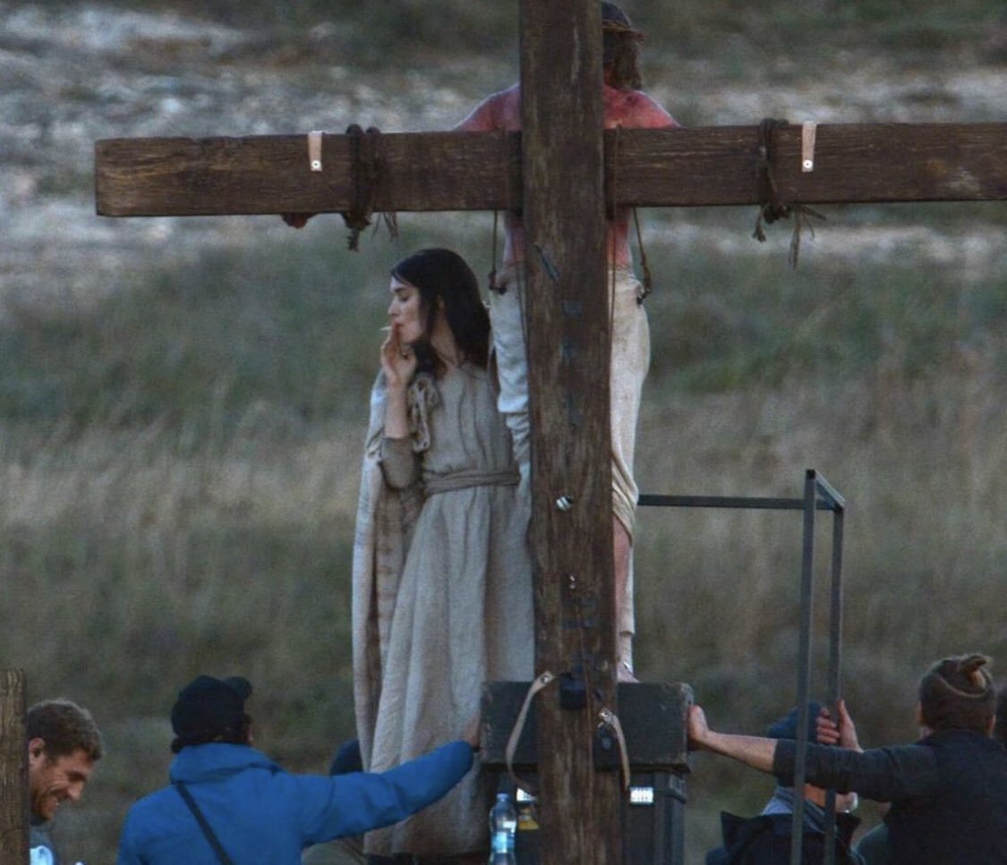 rooney mara as mary magdalene smoking in front of crucified jesus