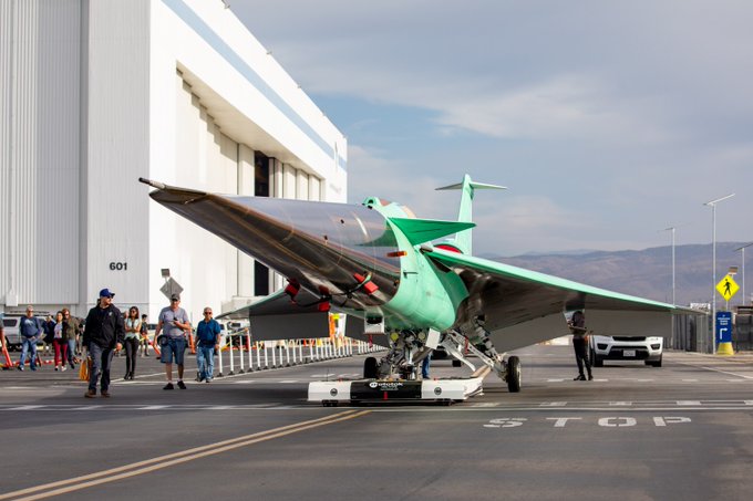 NASA’s X-59 research aircraft moved from its construction site to the flight line, or the space between the hangar and the runway, at Lockheed Martin Skunk Works in Palmdale, California on June 16, 2023. The move allowed the X-59 team to perform safety and structural testing, critical steps toward first flight. The X-59 can be seen in the foreground of this image, and in the background is a white hangar and blue sky. Image credit: Lockheed Martin.