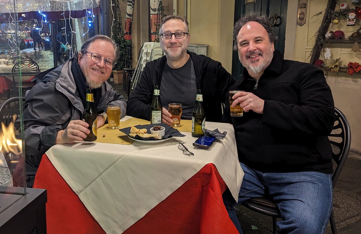 IllustratorJeff's tweet photo. Spent the early evening roaming Pisa in the rain with these two fellows. Damnation 3 starts tomorrow. Come check out the event and all the art. #mtg #mtgItaly #Damnation3 #RKPost #ChuckLukacs #mtgPisa https://t.co/Dqo8Nf7SMd