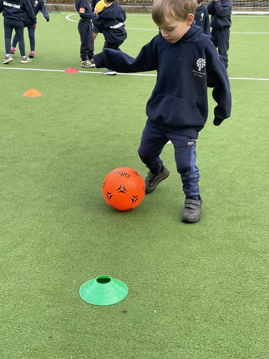 Today the children showed fantastic skill in PE, carefully dribbling the ball around the cones and running back to their team to cheer on the next person. Great work from everyone! ⚽️ <a href="/DanesfieldSchl/">Danesfield School</a>