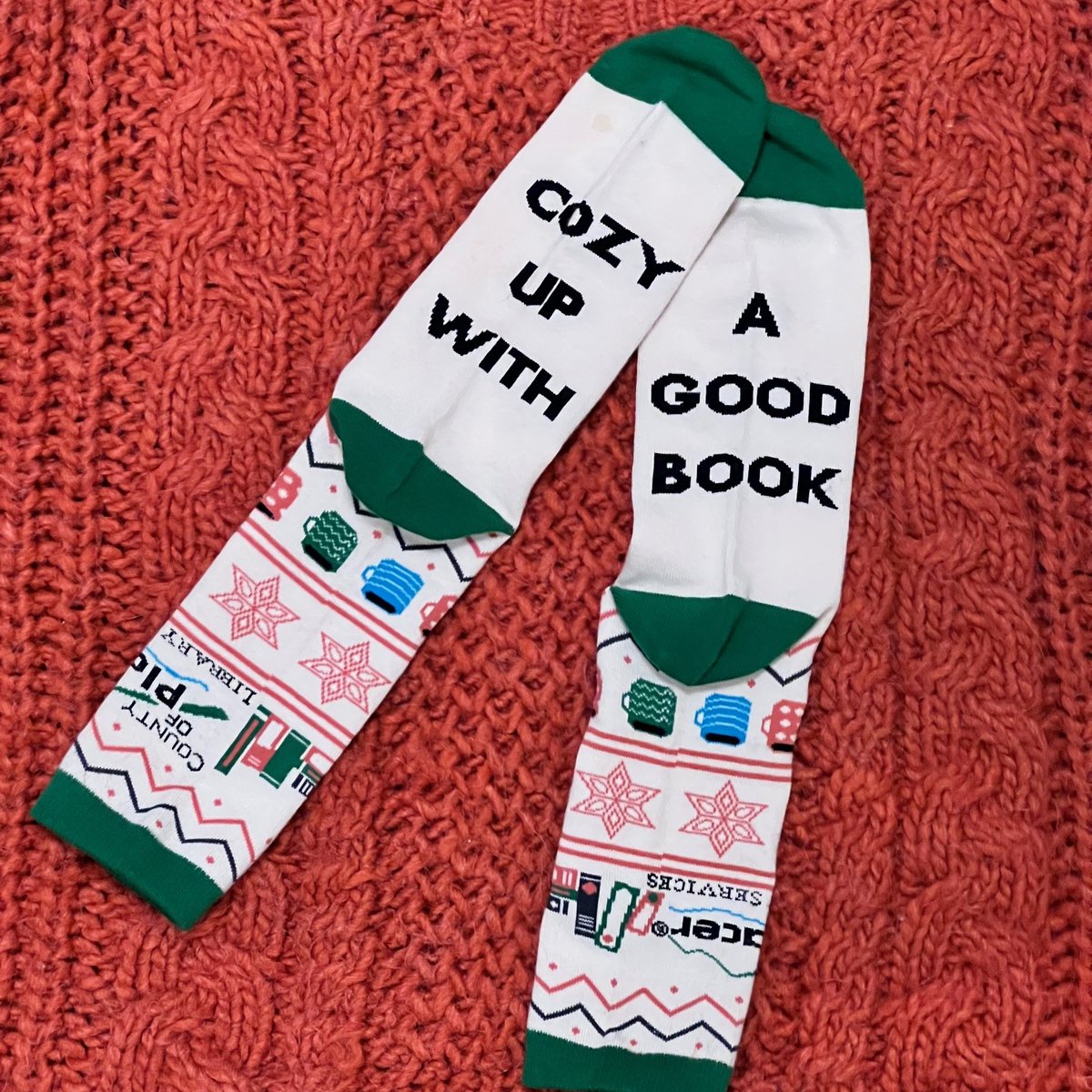 PlacerLibrary's tweet photo. The first 100 adults who finish Winter Book Bingo will earn a pair of these cozy Placer County Library socks! While supplies last. Join the challenge at https://t.co/2KzZIBSIVo or pick up a bingo card at your library! Hurry before they're gone! #BookBingo #LibrarySocks #BookSocks https://t.co/JCh1UrDWYl