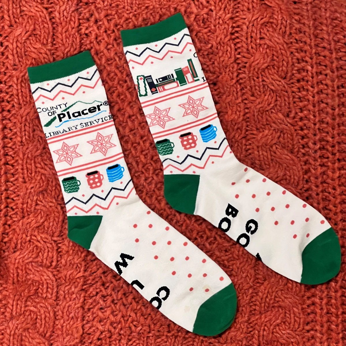 PlacerLibrary's tweet photo. The first 100 adults who finish Winter Book Bingo will earn a pair of these cozy Placer County Library socks! While supplies last. Join the challenge at https://t.co/2KzZIBSIVo or pick up a bingo card at your library! Hurry before they're gone! #BookBingo #LibrarySocks #BookSocks https://t.co/JCh1UrDWYl