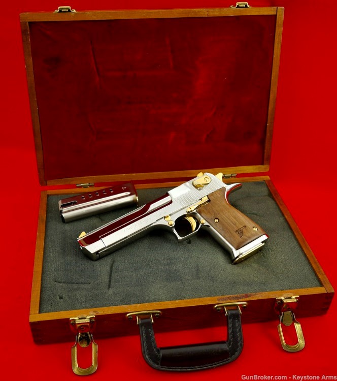 AutoMagArchive's tweet photo. IMI Desert Eagle .44 Magnum in chrome with gold accents and wood grips. https://t.co/2VSVgvrD6b