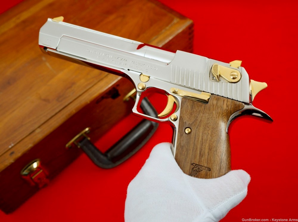 AutoMagArchive's tweet photo. IMI Desert Eagle .44 Magnum in chrome with gold accents and wood grips. https://t.co/2VSVgvrD6b