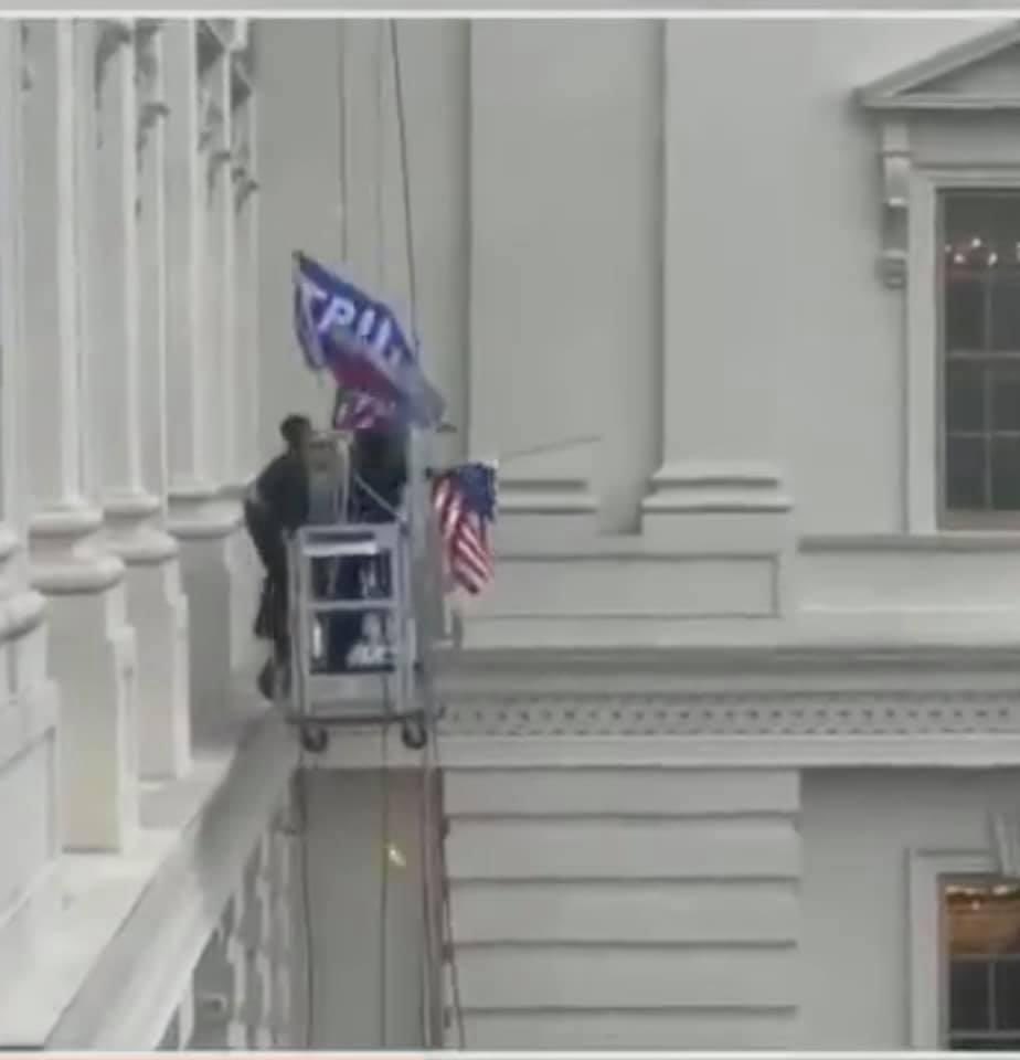 This was the moment when Trump supporters took down the US flag and threw it on the ground so the could replace it with a Trump flag.
