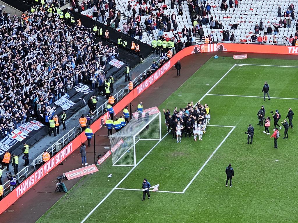 Impromptu team photo in front of the away end. Hasn't gone down well among the home fans who remain...