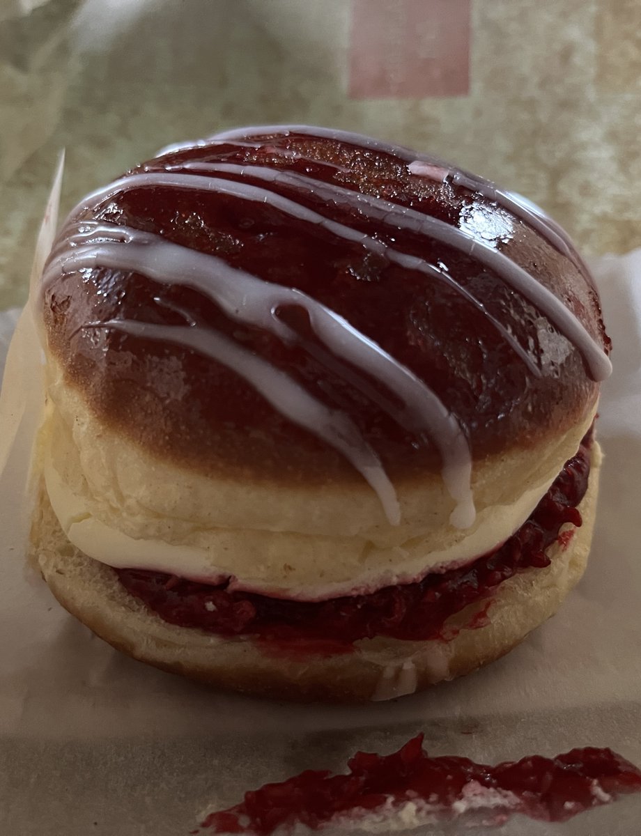 It's called a Himburger. 
Doughnut with raspberry and cream filling.
It really makes happy for the moment you eat it. 
And some seconds after. 
But it's sugar-poison. 
Anyway, I have eaten it.
Je ne regrette rien! ❤️
#heartfood
