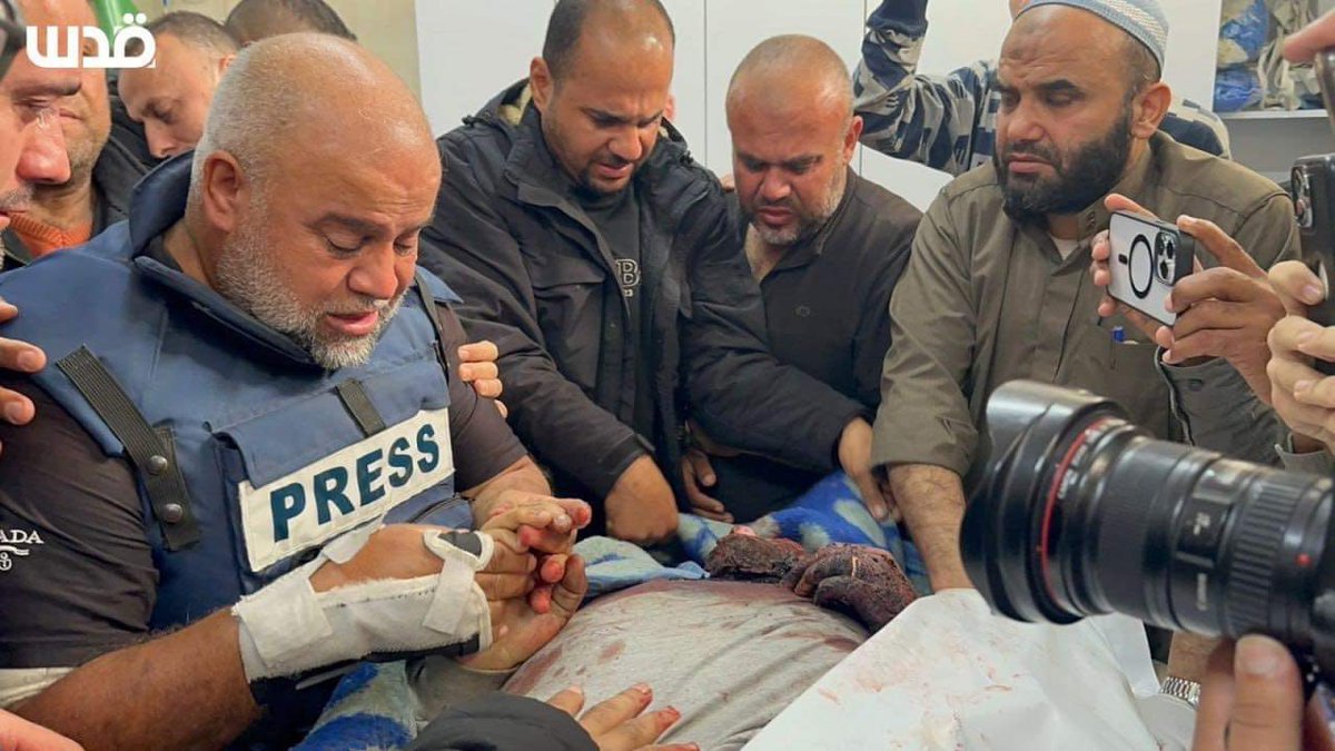 Journalist Wael Al Dahdouh casts a final gaze of farewell upon his son, the journalist Hamza.