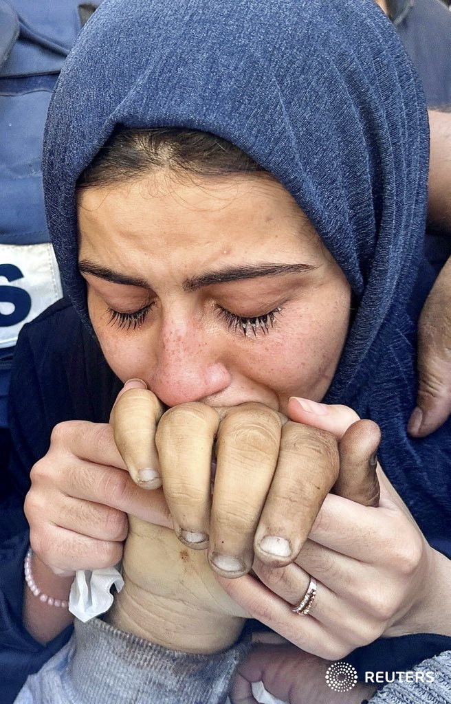 Sister of #Palestinian journalist Hamza Al-Dahdouh, the son of Al Jazeera #journalist Wael Al-Dahdouh, kisses his hand as she attends his funeral, after Hamza was killed in an Israeli strike, in #Rafah in the southern #Gaza Strip, January 7, 2024. REUTERS/Mohammed Salem #غزة