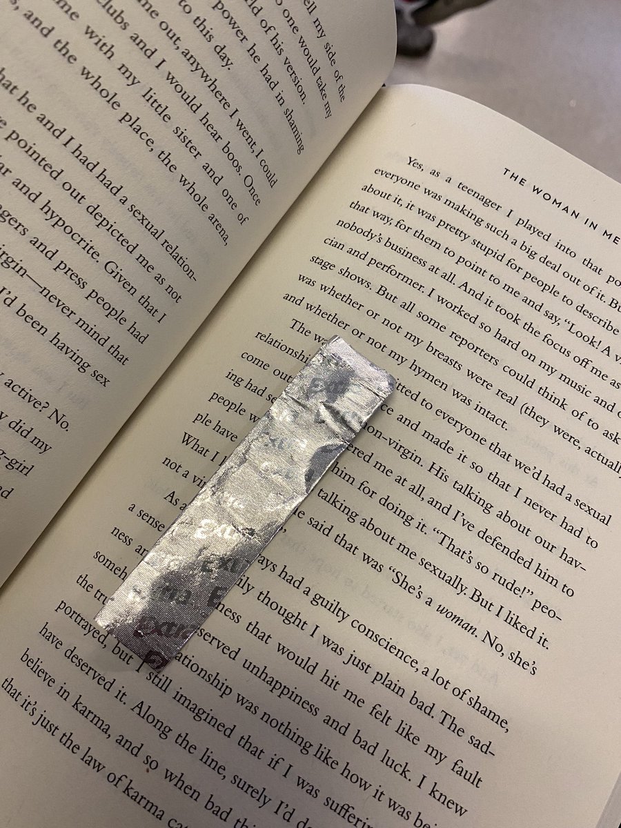 _MadeOfScars_'s tweet photo. I’m glad I have my book all I can do to distract myself from what I’m going through. I didn’t bring my EarPods. Old gum wrapper makes for an okayish book mark not that I can put it down but when the doctors come in I have to #WomanInMe #BritneySpears https://t.co/keBjGesB6k