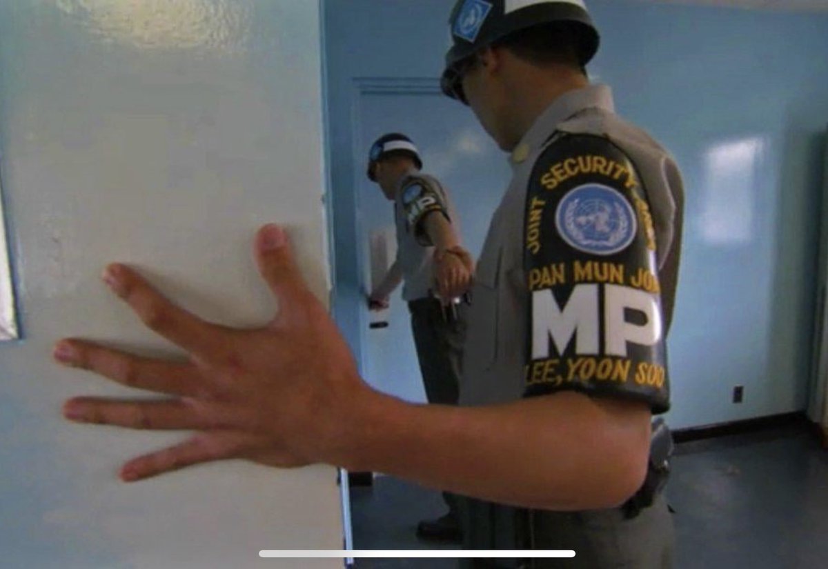 South Korean guards holding hands to prevent being pulled across the North Korean border. The Demilitarized Zone (DMZ) between North and South Korea is a heavily fortified and guarded area, serving as a buffer zone between the two countries. There’s a specific building within…