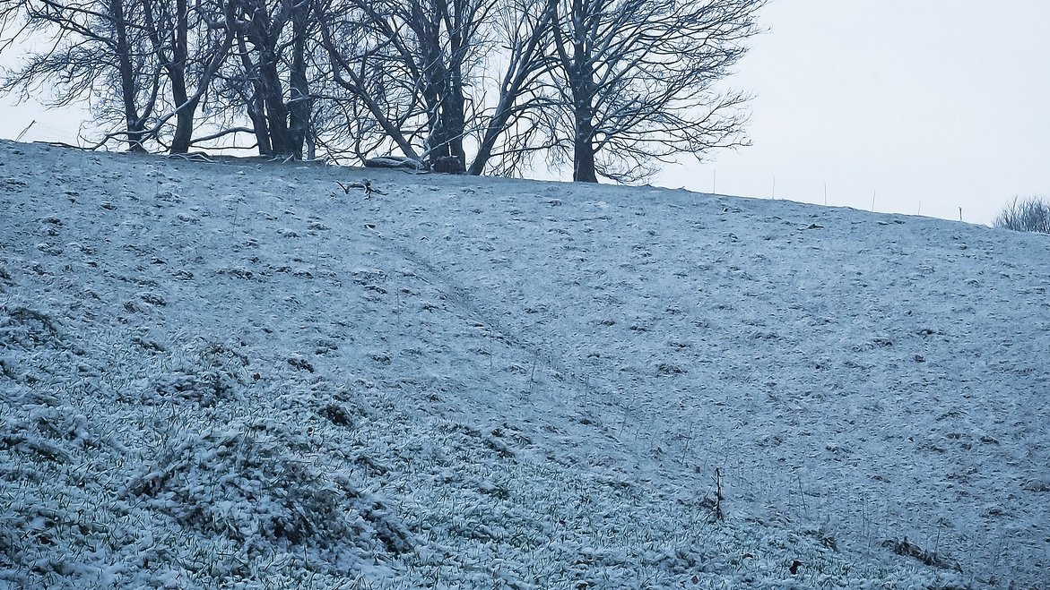 A FROSTMARK is a noticeable mark or shape that appears in the frost on an area of frozen ground, indicating where some former structure, such as a wall or ditch, once stood. In archaeology, frostmarks can even be used to locate ancient features now lost beneath the surface.