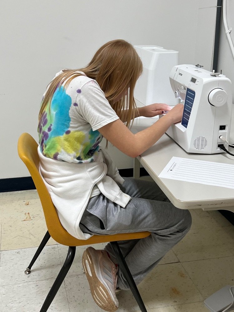 OkawValley's tweet photo. OVMS now has a sewing class for one of the explore classes.  We learned to sew on buttons today and started learning how to operate a sewing machine.  I am very excited to see how far they will go! #YNotOV https://t.co/azvB9chBEQ