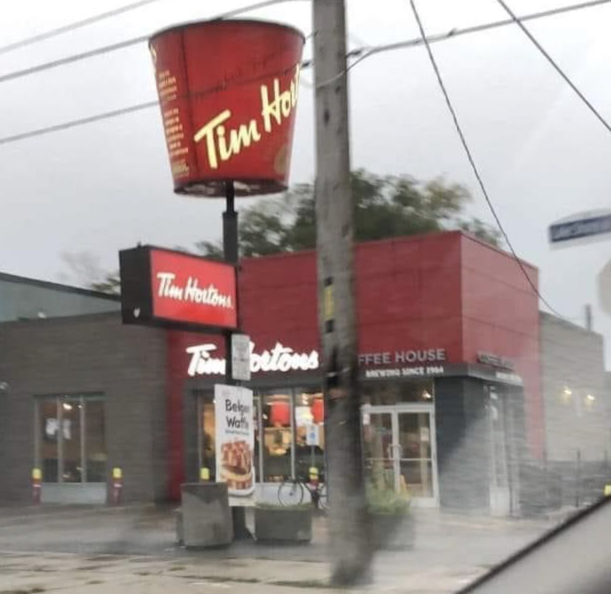 MadelnCanada's tweet photo. A Tim Hortons that took over a KFC and kept the ‘bucket’ on the post 😂 https://t.co/uYXO8ncHiU