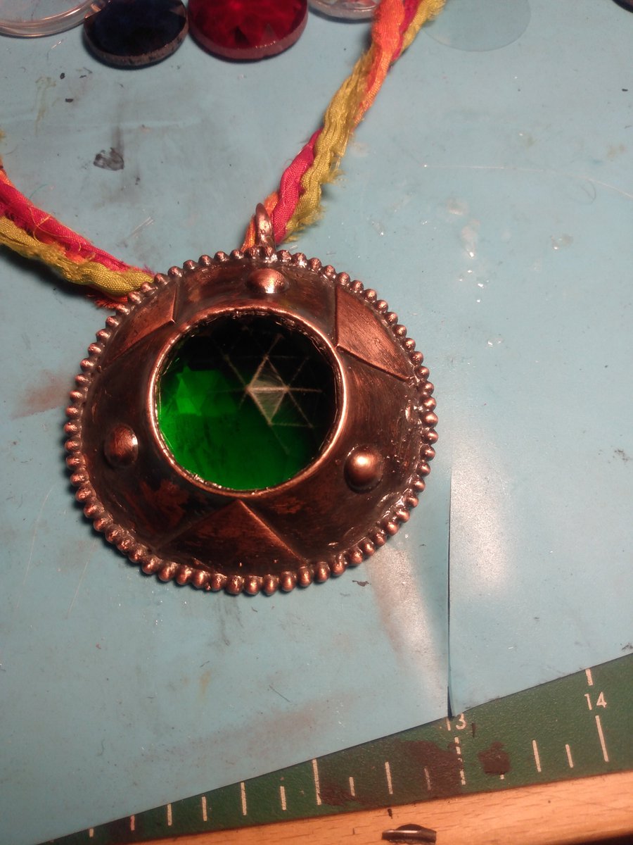 Electroformed copper pendant with green glass, silk cord made from scraps of saris.