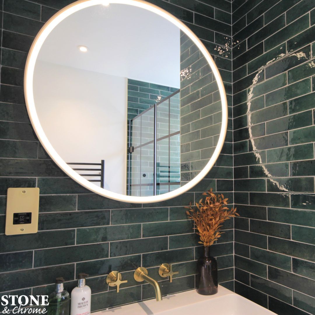 Dare to be bold? Green tiles and brushed brass are the perfect combination! 💚 - Coalbrook Bank three tap hole, wall mounted basin mixer in Brushed Brass. - Roper Rhodes Frame round LED lit mirror with Brushed Brass trim. - Luminous Lume Green tiles by Minoli. --- 📞 01276 61000
