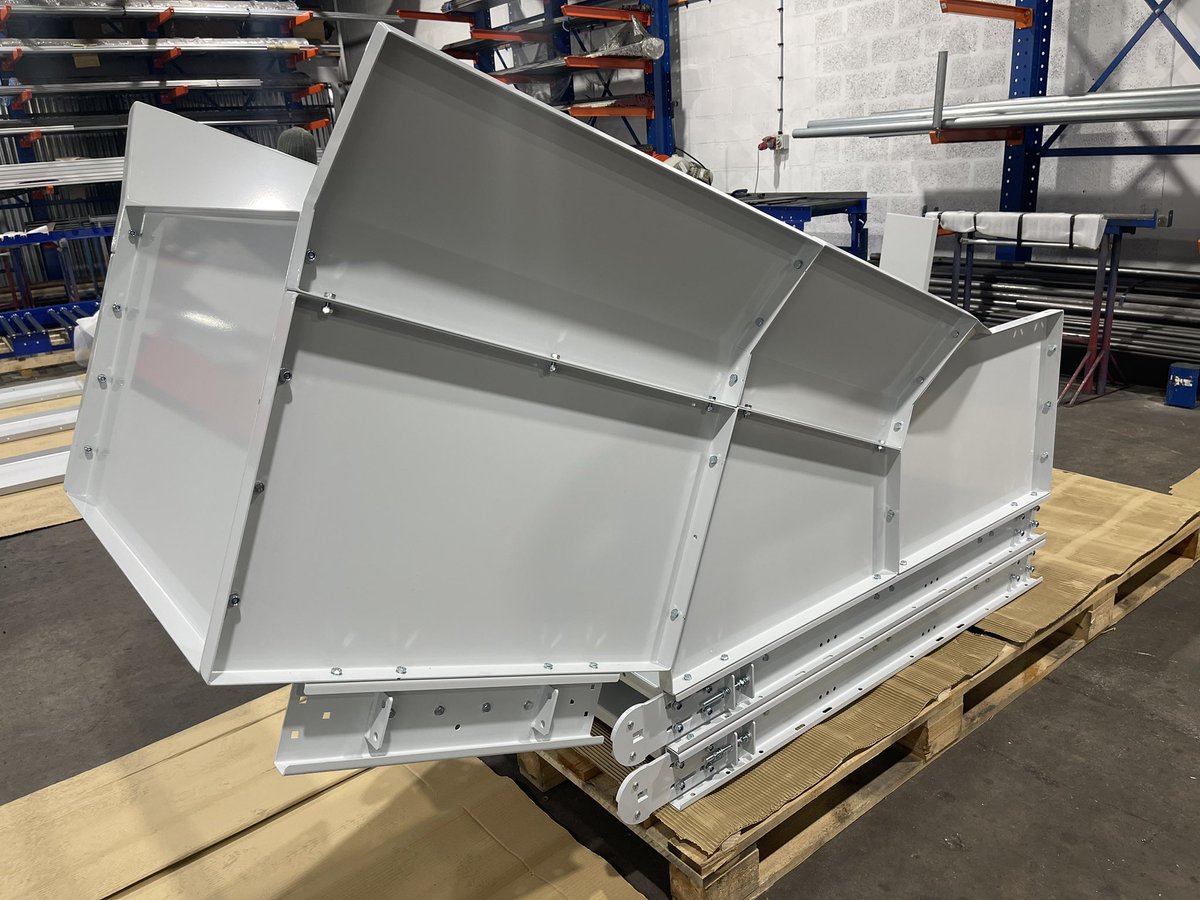 Customised side guarding and connection of two belt conveyors feeding bulk items.